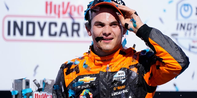 Pato O'Ward, of Mexico, celebrates after winning an IndyCar Series auto race, Sunday, July 24, 2022, at Iowa Speedway in Newton, Iowa. (AP Photo/Charlie Neibergall)
