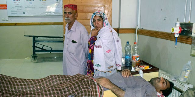 A man injured in a bus accident in Dana Sar, Khyber Pakhtunkhwa province, is treated at a hospital in Quetta, Pakistan, Sunday, July 3, 2022. An official said the passenger bus slid off a mountain road and fell 200 feet (61 meters) into a ravine in heavy rain killing at least 18 people and injuring some 12 others. 
