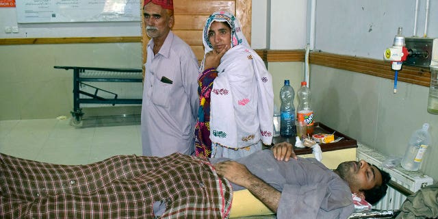 A man injured in a bus accident in Dana Sar, Khyber Pakhtunkhwa province, is treated at a hospital in Quetta, Pakistan, Sunday, July 3, 2022. An official said the passenger bus slid off a mountain road and fell 200 feet (61 meters) into a ravine in heavy rain killing at least 18 people and injuring some 12 others. 