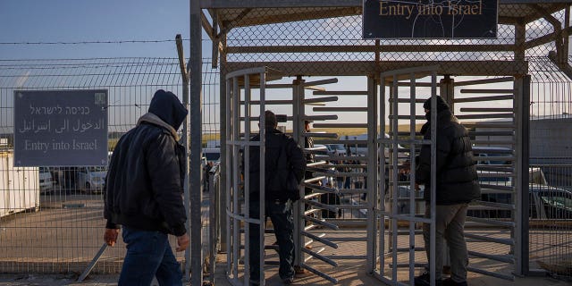 Palestinian workers enter Israel after crossing from Gaza on the Israeli side of the crossing between Israel and the Gaza Strip, March. 27, 2022.