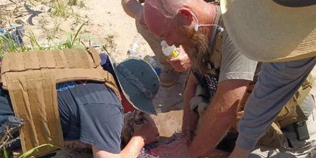 Patriots for America members aid a migrant at the Texas border.