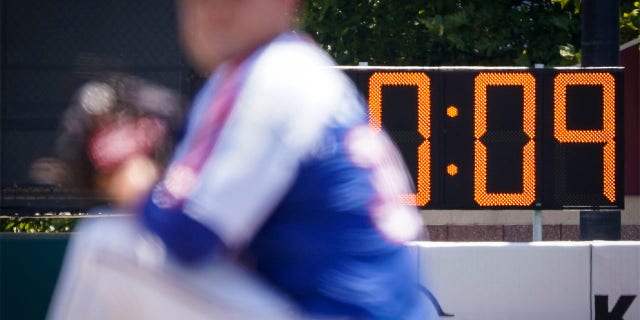 A pitch clock is deployed to restrict pitcher preparation times during a minor league baseball game between the Brooklyn Cyclones and Greensboro Grasshoppers, Wednesday, July 13, 2022, in the Coney Island neighborhood of the Brooklyn borough of New York. Major League Baseball is considering a pitch clock for next year along with shift limits, larger bases and restrictions on pickoff attempts.