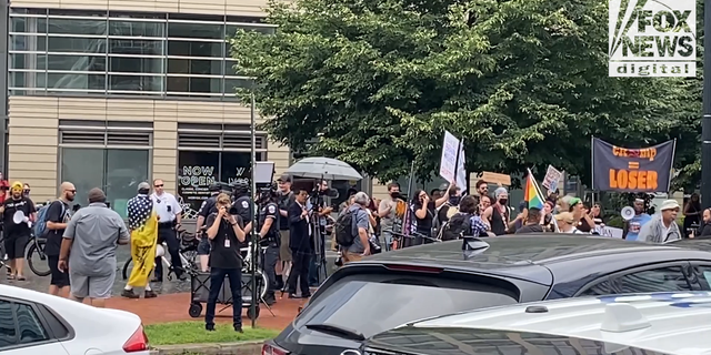 Liberal and conservative protesters shouted at each other across the street in front of the venue of former President Donald Trump's speech to the America First Agenda Summit.