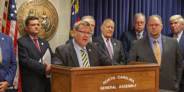 Speaker of the North Carolina House of Representatives Timothy Moore gives speech alongside General Assembly members. 
