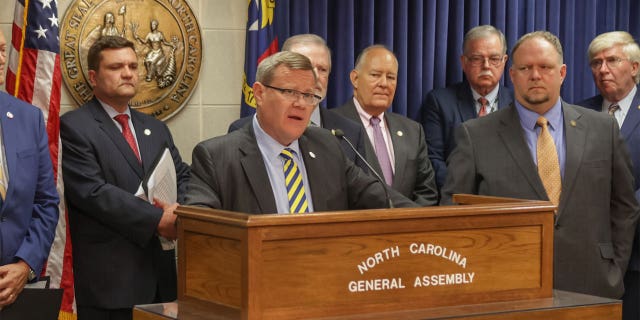 Speaker of the North Carolina House of Representatives Timothy Moore gives a speech alongside General Assembly members.