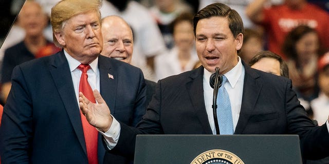 Former President Donald Trump and Florida GOP Gov. Ron DeSantis stand alongside one another at a rally in August 2022.