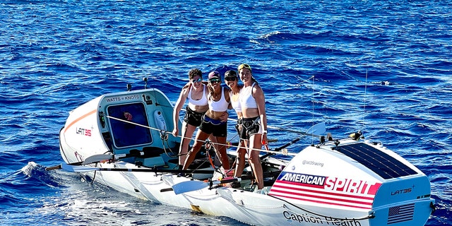Lat35 rowers Libby Costello, Sophia Denison-Johnston, Brooke Downes and Adrienne Smith pose at the finish line of the Great Pacific Race in Waikiki, Hawaii, on July 25, 2022.