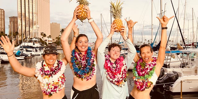 Lat35 rowing team members Libby Costello, Sophia Denison-Johnston, Brooke Downes and Adrienne Smith celebrate on July 25, 2022, after breaking the world record for the fastest row across the Pacific Ocean.