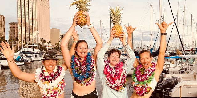 Lat35 rowing team members Libby Costello, Sophia Denison-Johnston, Brooke Downes and Adrienne Smith celebrate on July 25, 2022, after breaking the world record for the fastest row across the Pacific Ocean.