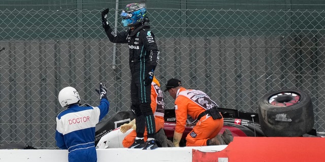 Fellow driver George Russell ran to Zhou's car to see if he could help the stewards.