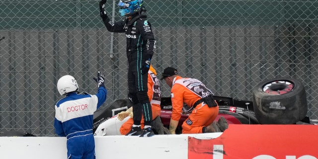 Fellow driver George Russell ran to Zhou's car to see if he could help the stewards.