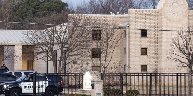 Police gather in front of the Congregation Beth Israel synagogue, Sunday, Jan. 16, 2022, in Colleyville, Texas. In January, four people were taken hostage by a pistol-wielding man during a Shabbat service. 