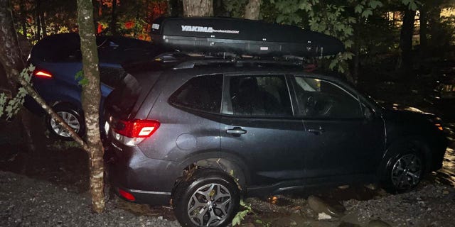 Two cars that were swept away by floodwaters Tuesday night.