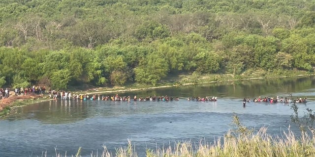 Migrants stream across the Texas border.