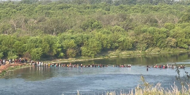 Migrants stream across the Texas border.