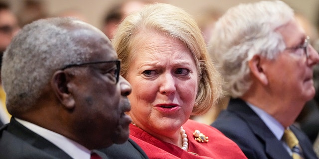 Supreme Court Justice Clarence Thomas sits with his wife Virginia Thomas while he waits to speak at the Heritage Foundation on Oct. 21, 2021, in Washington.