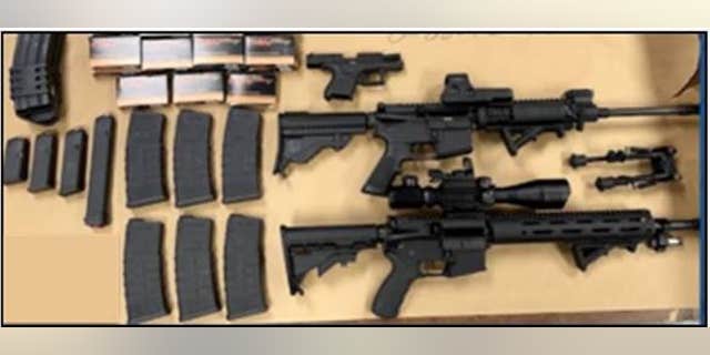 Two rifles, a handgun, a cache of magazines, and several hundred rounds of ammunition. ammunition