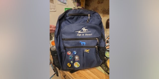 Kaylee Jones may be carrying a blue backpack with pins and an embroidered horse-shaped patch.
