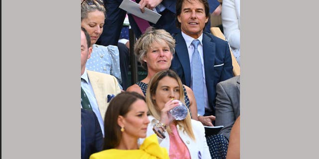 Kate, Duchess of Cambridge (front) and US actor Tom Cruise (rear) attend the women's singles final tennis match between Kazakhstan's Elena Rybakina and Tunisia's Ons Jabeur on the thirteenth day of the 2022 Wimbledon Championships at The All England Tennis Club in Wimbledon, southwest London, on July 9, 2022.