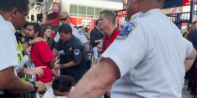 Police arrest a climate protester outside Nationals Park during the Congressional Baseball Game.