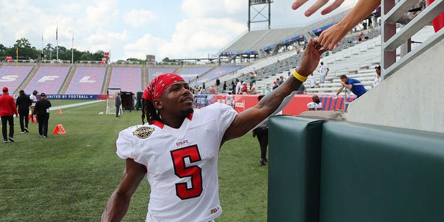 KaVontae Turpin of the New Jersey Generals high-fives fans after defeating the Michigan Panthers 25-23 at Protective Stadium on June 11, 2022, in Birmingham, Alabama.