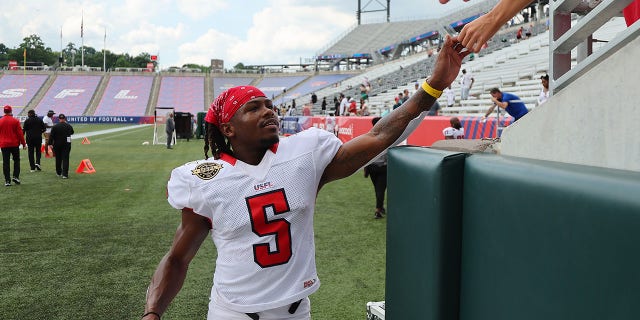 KaVontae Turpin of the New Jersey Generals high-fives fans after defeating the Michigan Panthers 25-23 at Protective Stadium on June 11, 2022, in Birmingham, Alabama.