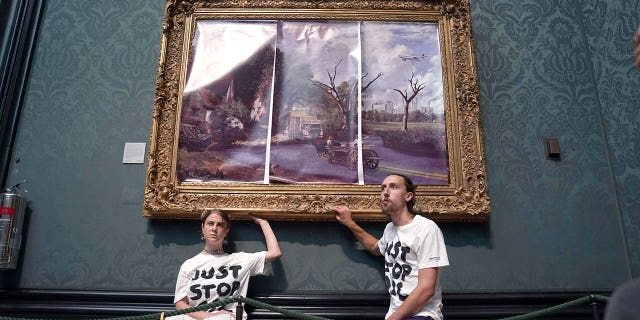 Protesters with the group "Just Stop Oil" glue their hands to the frame of John Constable's The Hay Wain inside the National Gallery in London on July 4. 