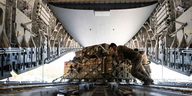 A pallet of fuses for 155 mm shells, ultimately bound for Ukraine, is spun as it's loaded on to a C-17 cargo aircraft, April 29, 2022, at Dover Air Force Base, Del.