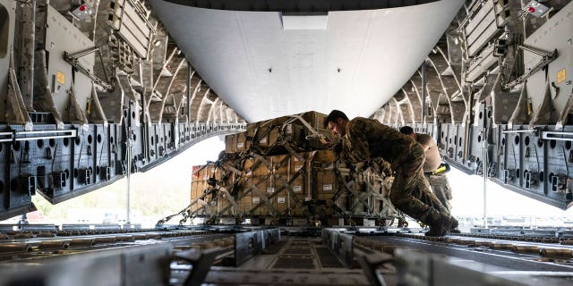 A 155mm bullet fuse pallet, ultimately destined for Ukraine, is spun as it is loaded onto a C-17 cargo plane on April 29, 2022, at Dover Air Force Base, Del. 