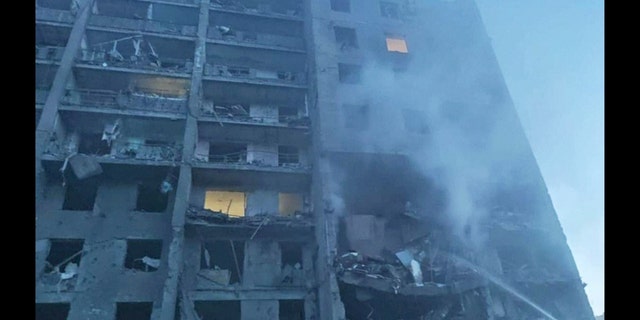 First responders try to extinguish flames at a residential building in Odesa, Ukraine, July 1, 2022, following Russian missile attacks. 