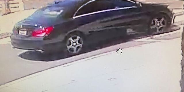 U.S. Postal Inspection Service (USPIS) spokesman Michael Martel showed an image at a press conference of a black Mercedes believed to be the suspect vehicle in an armed robbery on a mail carrier in Northwest Washington, D.C.