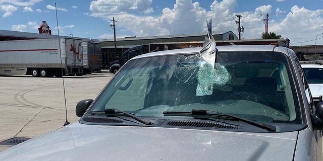 A metal object crashed through the windshield of a vehicle on I-25 in Salt Lake City on Wednesday.