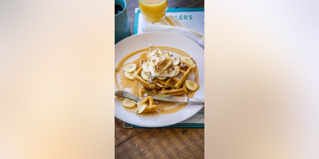 These homemade waffles include bananas, caramel and maple syrup.