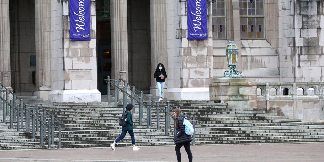 Students at the University of Washington are shown on campus in Seattle in March of 2020.