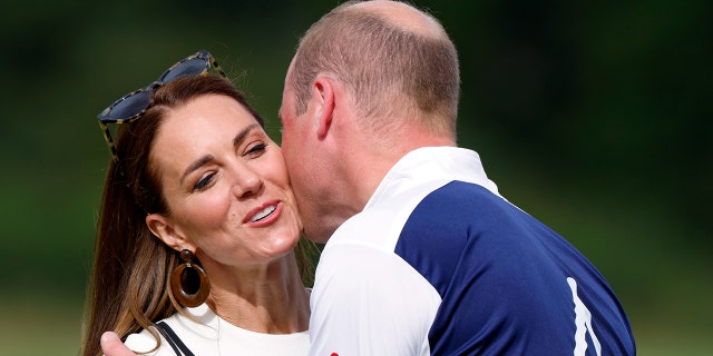 Kate, Duchess of Cambridge kisses Prince William, Duke of Cambridge during the prize-giving of the Out-Sourcing Inc. Royal Charity Polo Cup at Guards Polo Club, Flemish Farm on July 6, 2022 in Windsor, England.