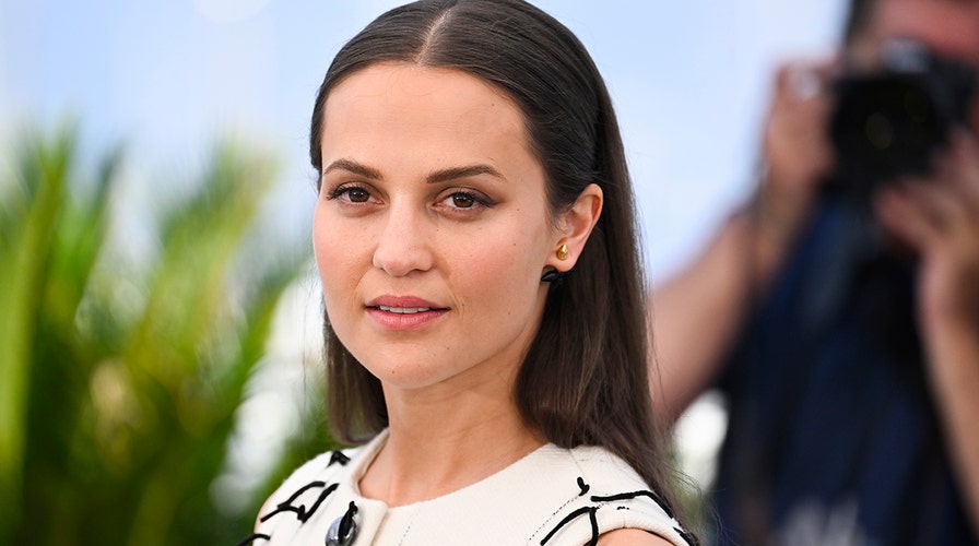 Alicia Vikander is every inch the doting mum as she enjoys a day