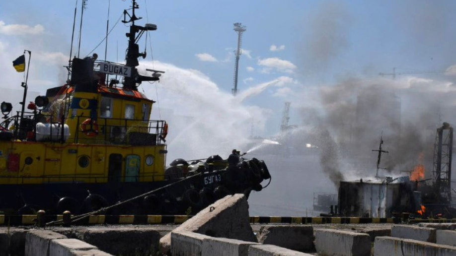 firefighters put out a fire in the port after a Russian missiles attack in Odesa