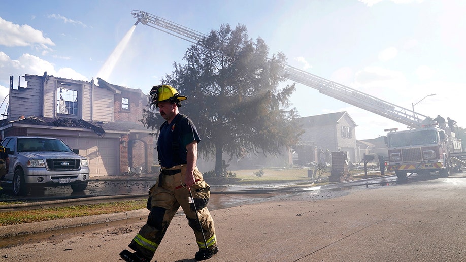 A firefighter walking while fighting a fire in Texas
