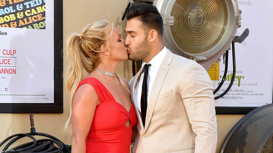 Britney Spears and her husband Sam Asghari sharing a kiss