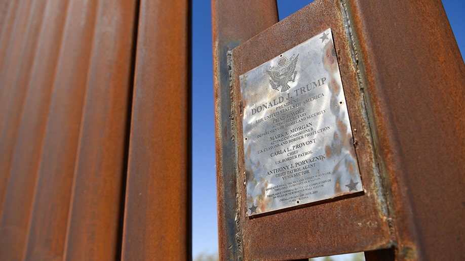 A plaque with Donald Trump's name on a Yuma border wall section