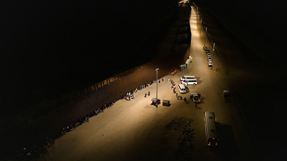 A photo of the border wall at night