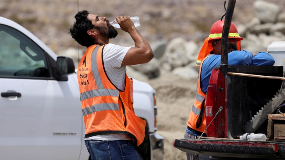 A California construction worker drinks water