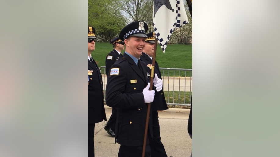 Chicago police officer Danny Golden carries a flag in a procession in uniform