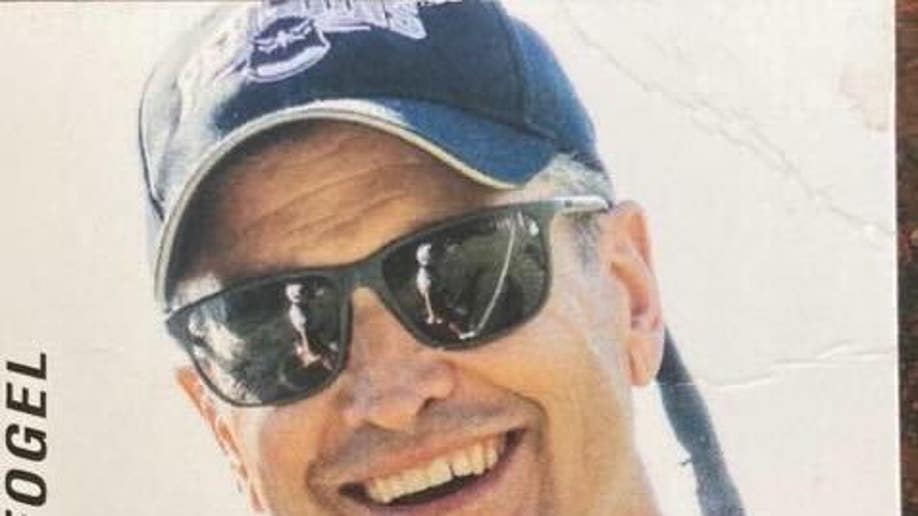 Marc Fogel smiling wearing a baseball cap and sunglasses