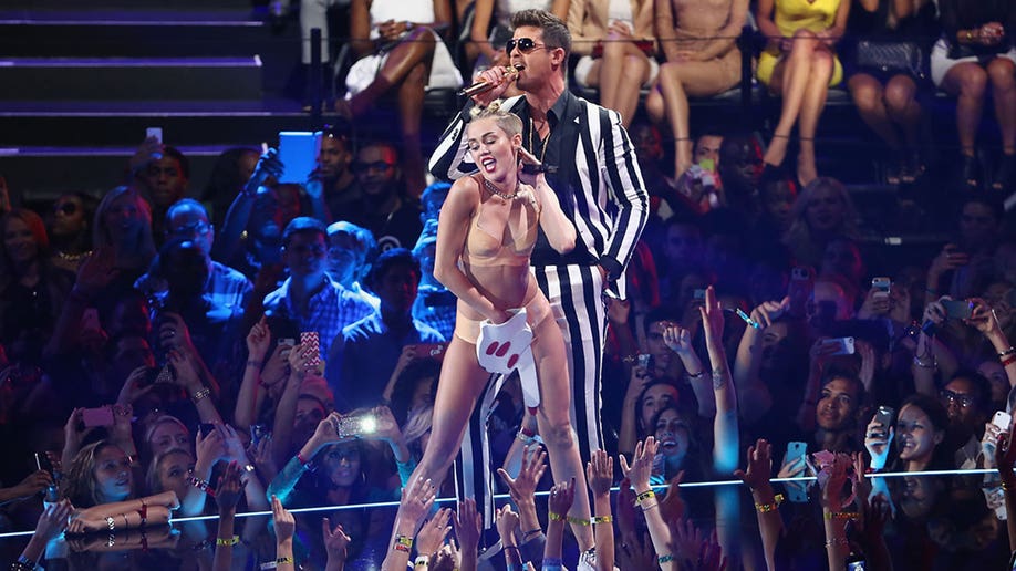 Miley Cyrus and Robin Thicke performing onstage during the 2013 MTV Video Music Awards 