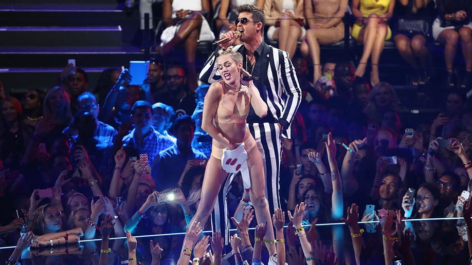 Miley Cyrus and Robin Thicke performing onstage during the 2013 MTV Video Music Awards