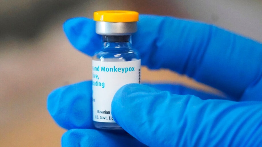 Person wearing gloves holds vial of Monkeypox vaccine