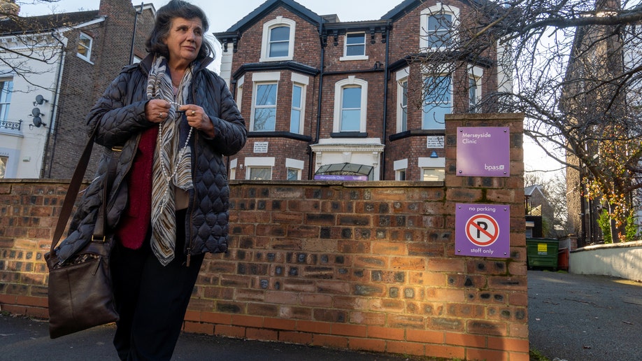 Rosa Lalor, an elderly British Lady with a rosary, stands outside an abortion clinic, praying