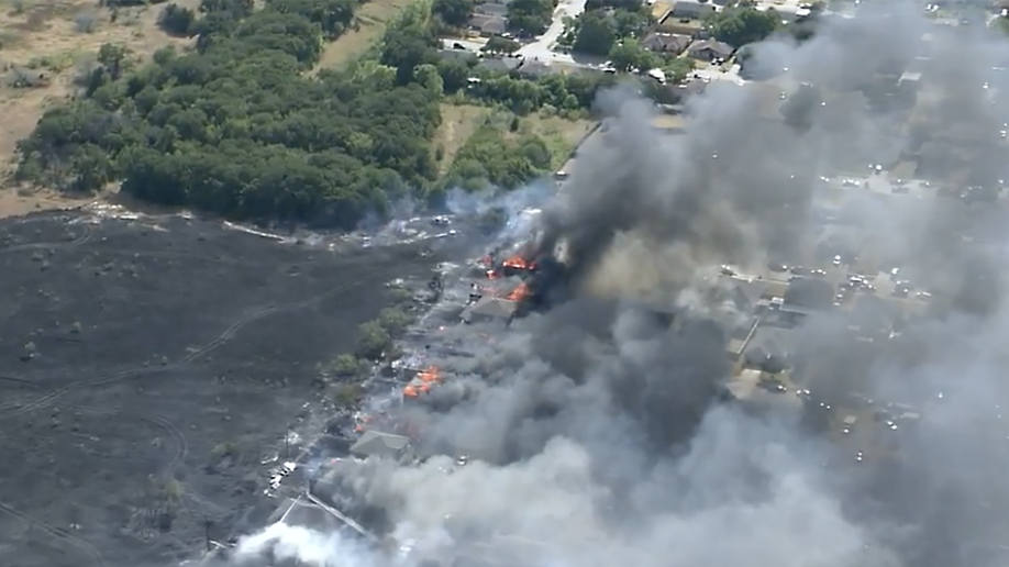 A photo showing black smoke rising from several buildings