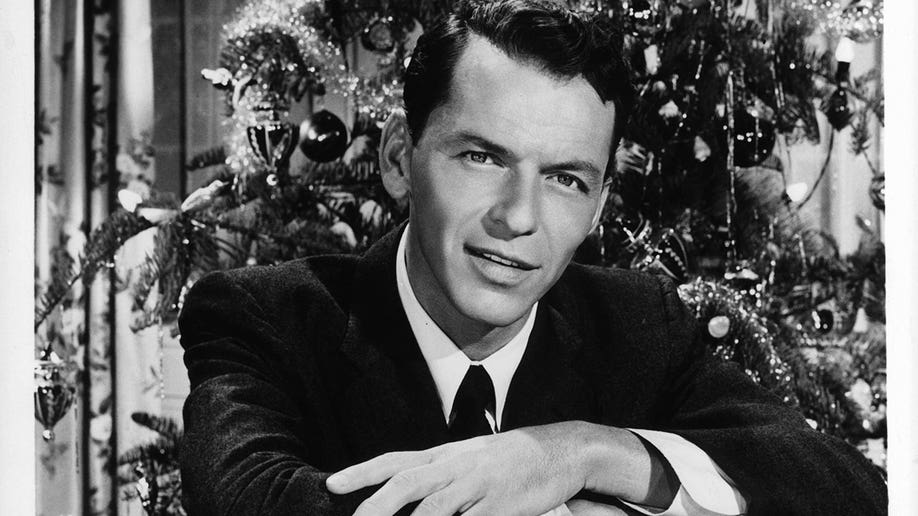 Frank Sinatra in front of a Christmas tree in 1954.